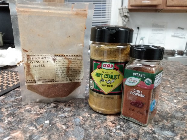 One of these things doesn't belong here. (A lineup o cayenne pepper, hot curry powder and chili powder).