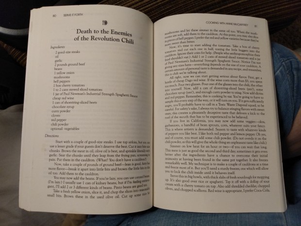 A photo of the book open to the page for David Gerrold's "Death to the Enemies of the Revolution Chili", which spans two full pages (and a bit of the following page, not pictured). Sorry, I'm not transcribing the recipe.